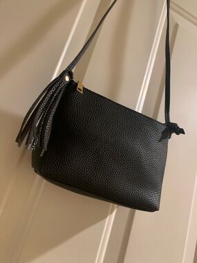 Classic Black Pebbled Leather Crossbody Bag with Tassel Accent